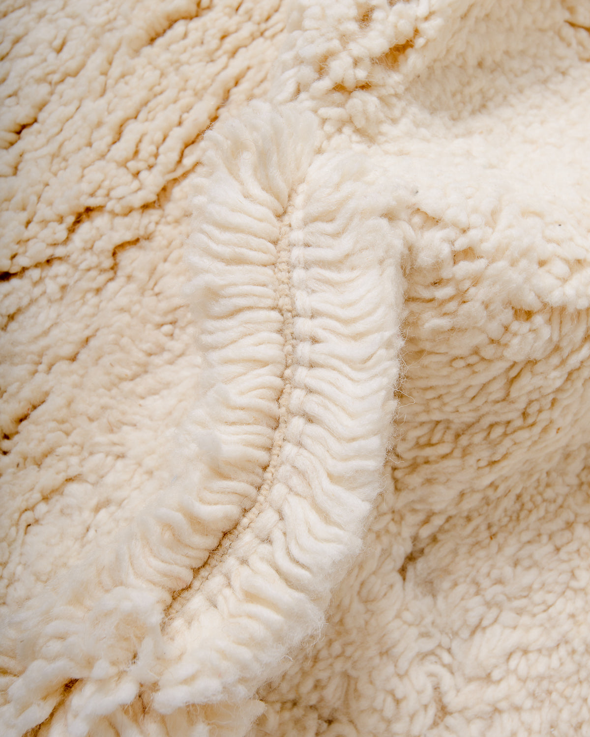 Modern, designer, handcrafted Berber rug from Morocco. Beniourain carpet with minimalist design, natural wool pile and a fluffy texture.